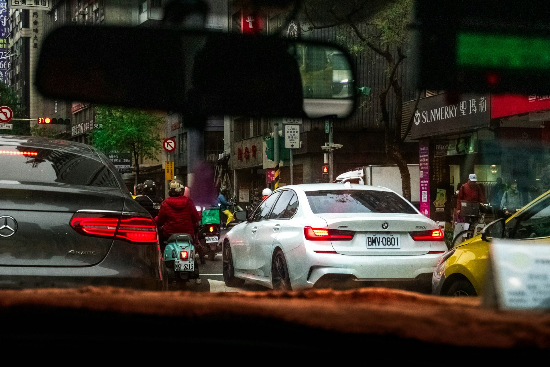 Cars and scooter in city traffic jam