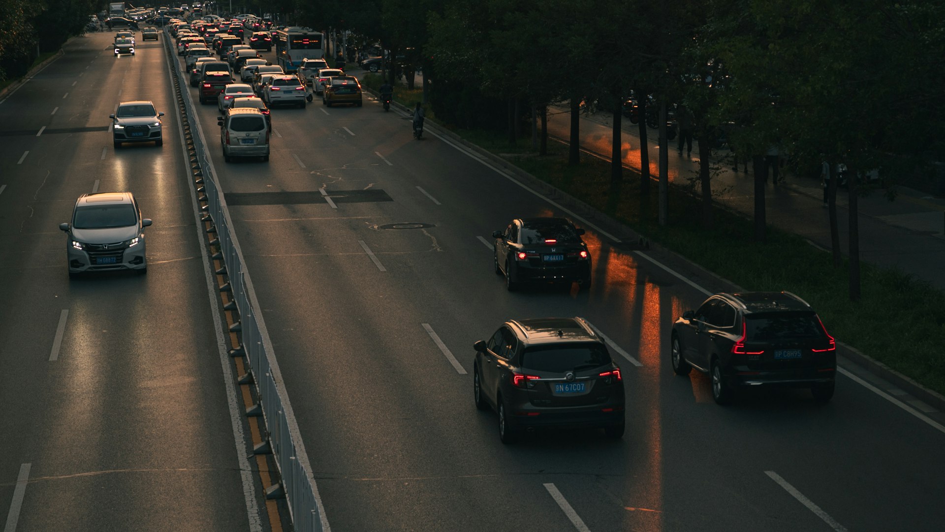 A highway filled with lots of traffic next to trees